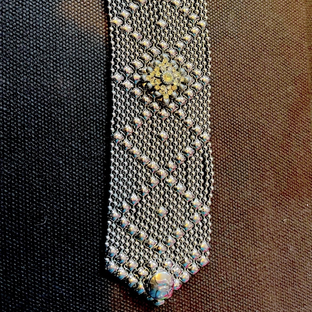 Wide silver bracelet with crystal center.